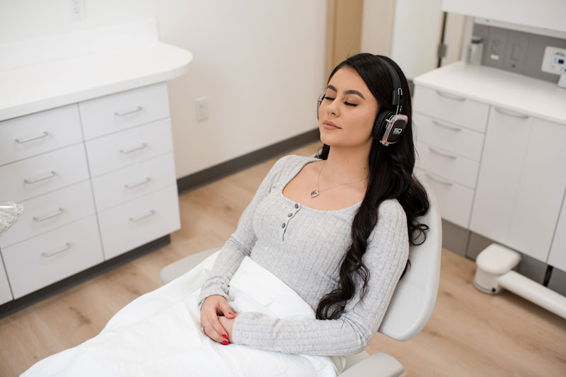 Relaxed patient listening to music on headphones